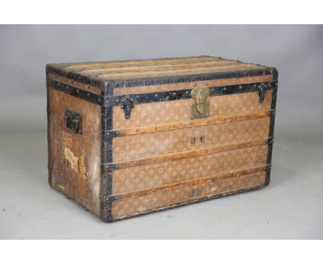 A late 19th/early 20th century Louis Vuitton travelling trunk with overall monogram and quatrefoil decorated canvas covering,