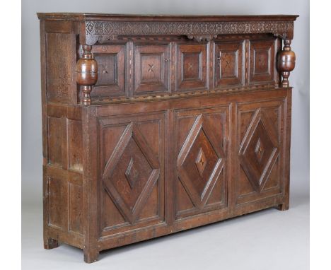 A large 17th century oak court cupboard with parquetry inlaid borders, the frieze with carved strapwork and dated '1653', eac