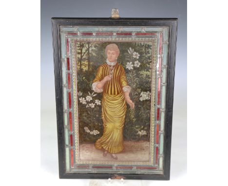A late 19th century Aesthetic Movement stained and leaded glass panel, painted with a full-length portrait of a lady within a