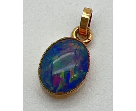A 9ct gold oval Australian boulder opal set pendant with closed back. Hallmarks to bale. Approx. 15mm x 7mm. 