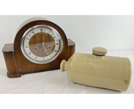 A vintage dark wood cased striking mantel clock together with stoneware Pearson, Chesterfield hot water bottle. Clock complet