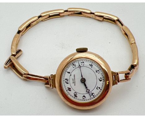 A vintage wristwatch by Kay Worcester with 9ct gold case and strap. White enamel face with black hour markers and hands. Expa