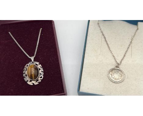 2 boxed silver pendant necklaces. An oval cabochon of Tigers Eye in a Celtic style mount, fully hallmarked to reverse, on an 