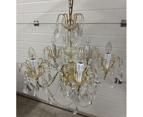 A modern brass and glass chandelier style ceiling light with plastic drops. Approx. 110cm drop but chain is adjustable to mak