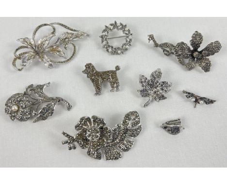 A collection of 8 vintage marcasite set brooches. To include Orchid flowers, Poodle and maple leaf designs. 