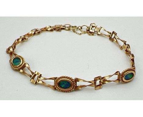 A 9ct gold decorative link bracelet with set 3 oval cut opal stones in bezel set mounts. With rope bead detail. Hallmarks to 