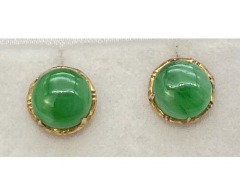 A pair of gold corkscrew post stud earrings each set with a round cabochon of green jade. Complete with backs. Test as 22ct g