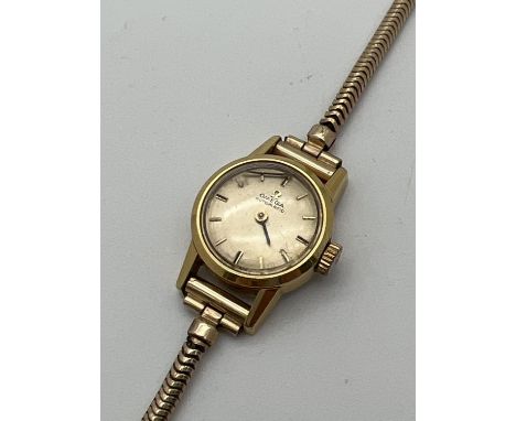 A ladies vintage 551002 automatic wristwatch by Omega. Gold tone case with rolled gold strap. One hand is loose inside watch 