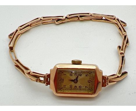 A ladies 9ct gold vintage 15 jewels Swiss made wristwatch. Rectangular shaped case with expanding bracelet strap. Inside of c