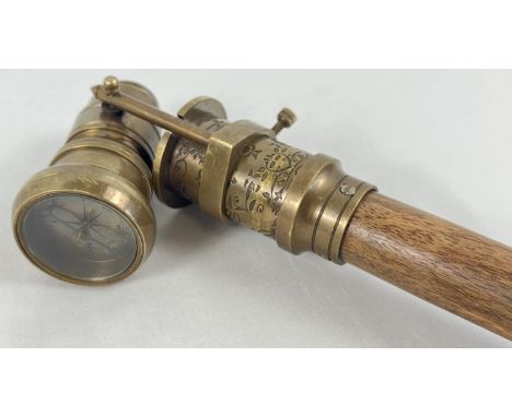 A reproduction wood and brass walking stick with swivel top telescope/compass handle. Approx. 95.5cm long in folded position.