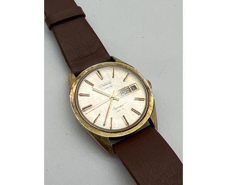 A men's vintage Aquastar Duward Ocenanic wristwatch. Gold tone case, hour markers and hands. With seconds hand and date funct