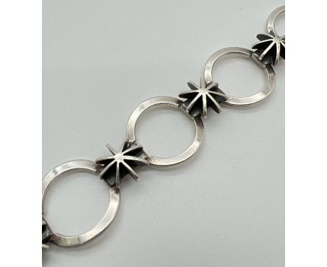 A 925 silver modern design star and circle link bracelet with push bar clasp and safety clip. Silver marks to back of bracele