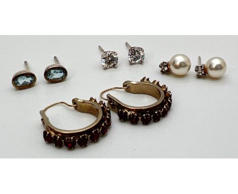 A small collection of silver and costume jewellery earrings. To include oval cut blue topaz studs, faux pearl and clear stone
