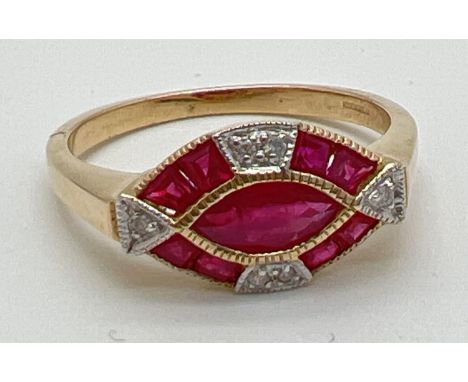 An Art Deco style ruby and diamond set dress ring by Luke Stockley, London. A marquise cut central ruby surrounded by 4 squar