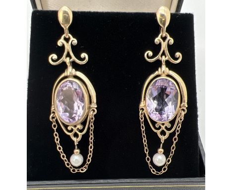 A pair of 9ct gold chandelier style drop earrings each set with an oval cut Rose De France amethyst, a white pearl and drop c