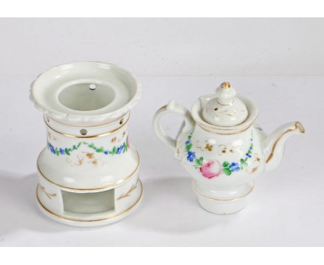 Late Victorian porcelain teapot on stand, having floral painted decoration lifting off the circular stand, 26cm high