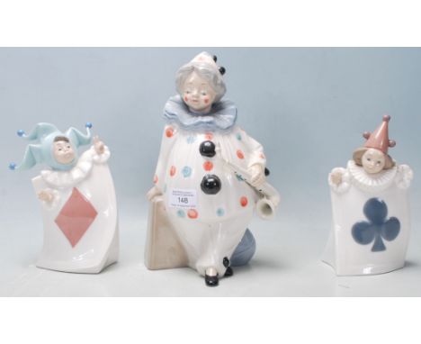 Three vintage 20th Century Valencian ceramic porcelain figurines comprising of a large clown holding a saxophone and two smal