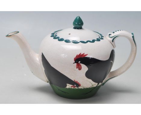 A rare early 20th century Bristol Poutney Cock &amp; Hen pattern pottery ceramic teapot and matching creamer jug designed by 