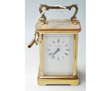 A mid 20th Century brass carriage clock retailed by Northern Goldsmiths Company having a carry handle to the top, faceted gla