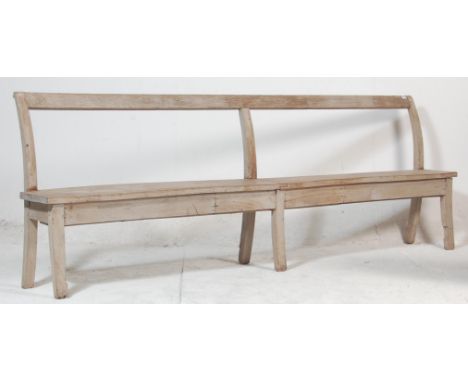 A 19th century Victorian elm wood station / railway / factory bench of rustic simple form. Raised on squared legs with planke