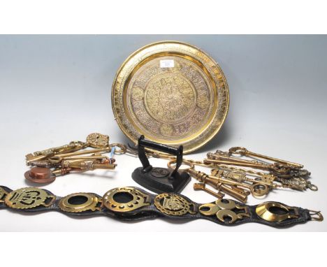 A collection of 20th Century brassware to include a Persian islamic wall charger plate with raised decoration, a good selecti