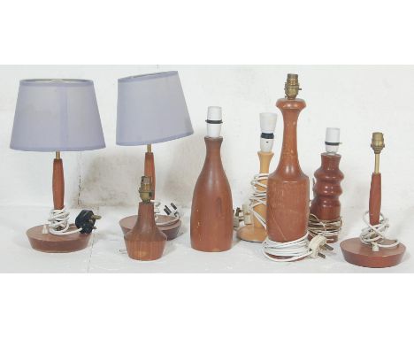 A large collection of retro vintage teak wood lamp bases having turned column, tapered shaped columns and bulbous form.&nbsp;