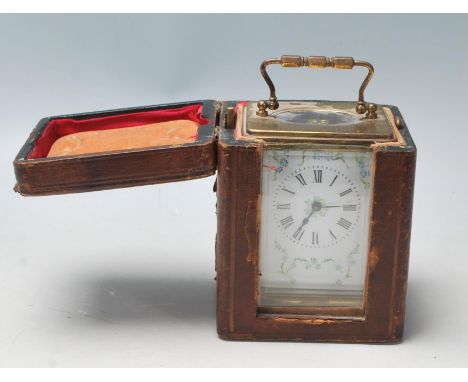 A 20th Century French Brass and glass carriage clock are having white enamel face, Roman numerals and blue and green flower d