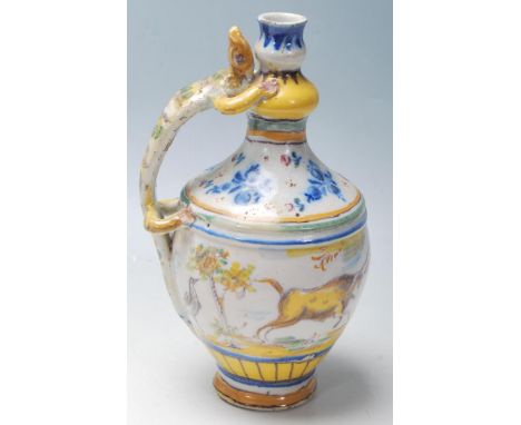 An antique 19th Century Majolica ceramic wine / water ewer jug having a lizard shaped handle, scenes of the countryside and b