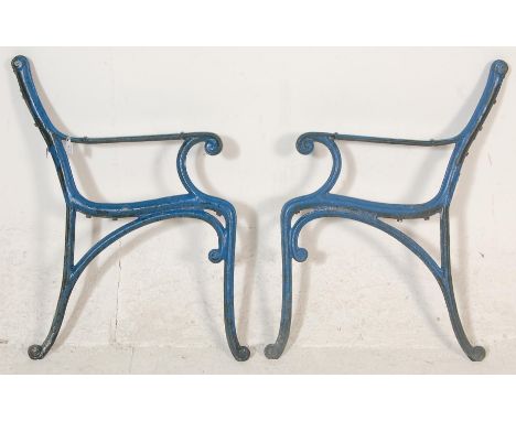 A pair of early 20th Century antique art nouveau style cast iron scroll work garden bench ends painted in teal.