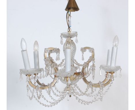 A 20th Century Italian cut glass ceiling chandelier having six branch arms with faux electric candles with a central baluster