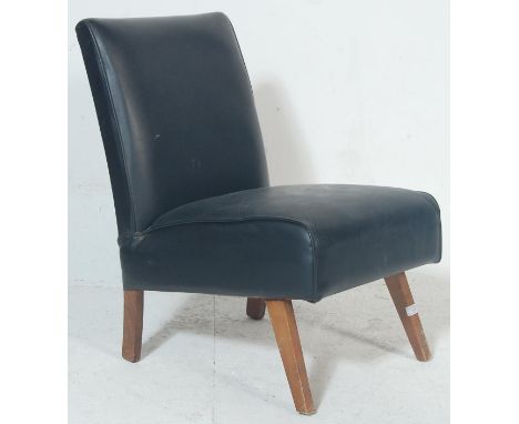 A vintage retro late 20th century bedroom chair having black leather upholstery raised on angular supports. Measures 80 cm hi