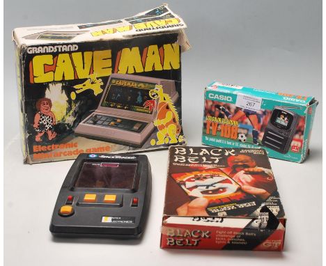 A collection of vintage retro 20th century computer electronic hand held games to include&nbsp; Grandstand Caveman. Black Bel