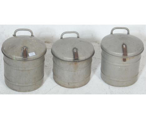 A set of three vintage 1950’s mid 20th century aluminium factory industrial food bins with hinged lid in a circular form with