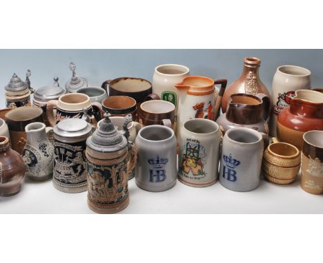 A large collection of 20th century assorted ceramic drinking vessels to include German stein tankards having typical raised m