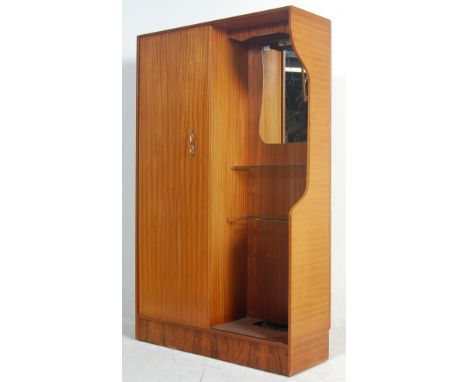 A retro vintage mid century 1950s teak wood lobby wardrobe cupboard compactum by Hubbi Robe having a sliding door to the left