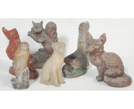 A large collection of vintage 20th century stone garden figurines / statues to include a fox, owl, dog, squirrel, and two gno