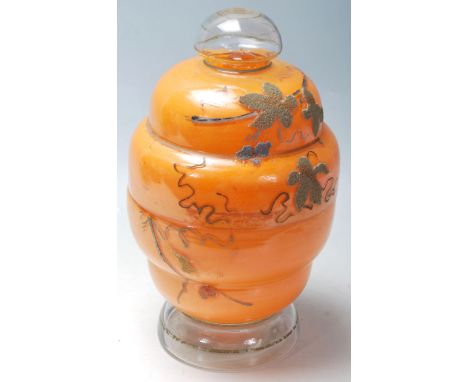 A vintage retro glass decanter and glass set housed in a glass in a tiered beehive shaped case, the case having having applie