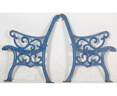 A pair of 20th Century&nbsp;antique &nbsp;cast iron scroll work garden bench ends painted in blue.