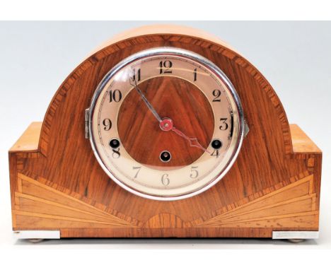 A retro vintage 1930's Art Deco walnut mantel clock having a dome top over a brass and wooden face with arabic numerals to th