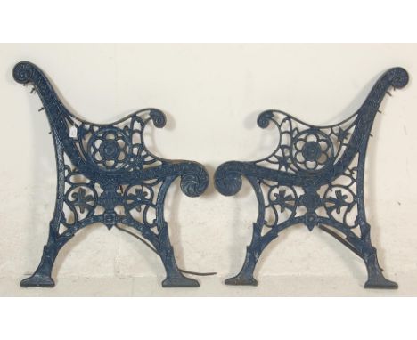 A pair of 20th Century antique&nbsp;cast iron scroll work garden bench ends painted in blue.