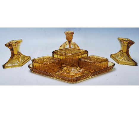 A vintage retro amber cast glass Art Deco 1930's dressing table set of diamond shape to include tray, three lidded boxes, thr