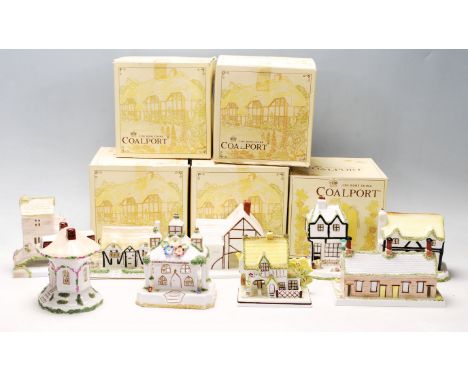 A collection of fine bone china cottages and florals by Coalport to include The Coaching Inn, Elizabethan Cottage, Thatched C