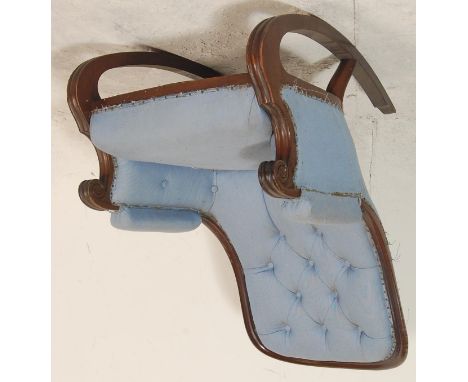 A 20th century Victorian style mahogany rocking chair having button back with scroll arm rest and curved rockers, blue fabric