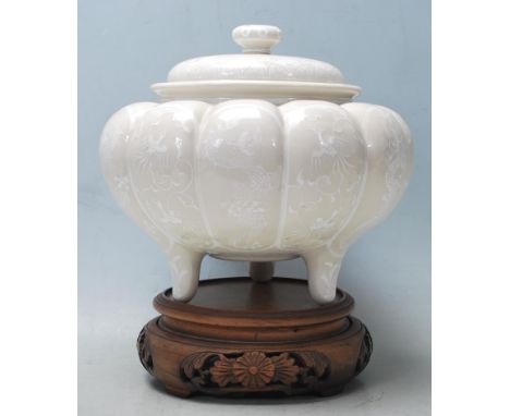 A 20th century Chinese ceramic&nbsp; jar of gourd form having panelled decoration to the sides with alternate Chinese dragon 
