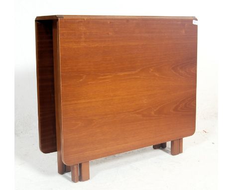 G plan - A retro vintage 1960s drop leaf Sutherland dining table by Gplan. The table having square hinged leaves on shaped ga