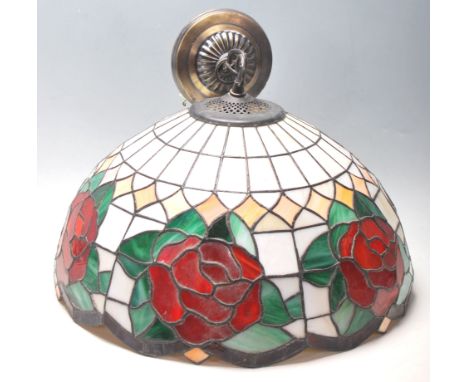 A 20th century Tiffany style leaded and stained glass ceiling chandelier - light. The bowl shade stylised with roses having c