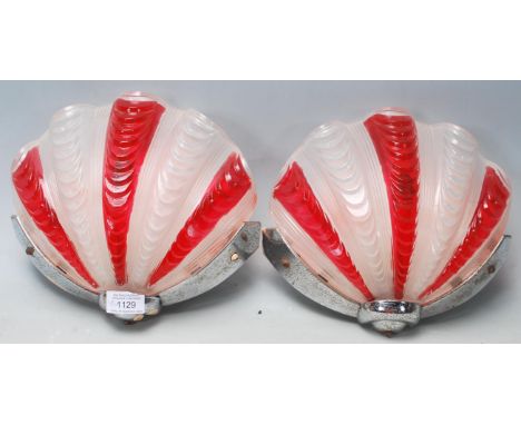 A pair of retro vintage 1960s glass shell wall light shades coloured in cherry and white having a chrome metal collar below a