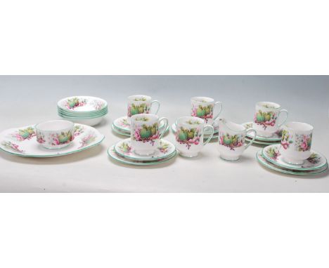 A 20th century Royal Albert bone china part tea service ' village green ' pattern tea service. The set comprising cups, sauce