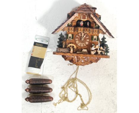 A late 20th Century mechanical articulated automaton German Cuckoo Clock by August Schwer of chalet form, featuring couples d