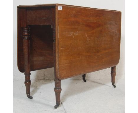 A 19th century George III mahogany drop leaf dining table. Raised on turned legs with castors having drop leaves being 3/4 le